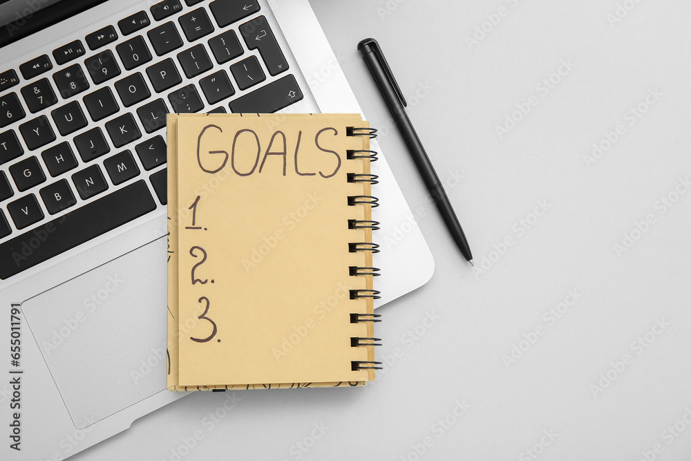 Notebook with empty to do list, laptop and pen on white background. New year goals