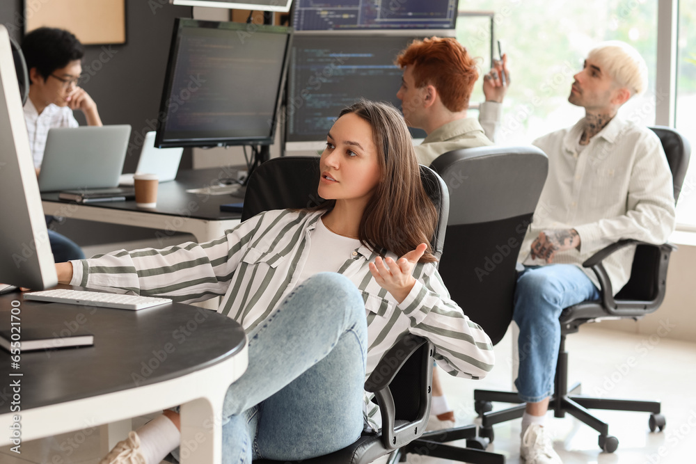 Female programmer working with computer in office