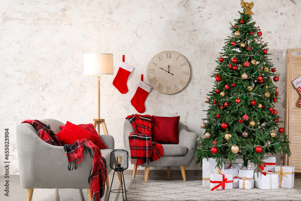 Interior of living room with Christmas tree, gift boxes and socks