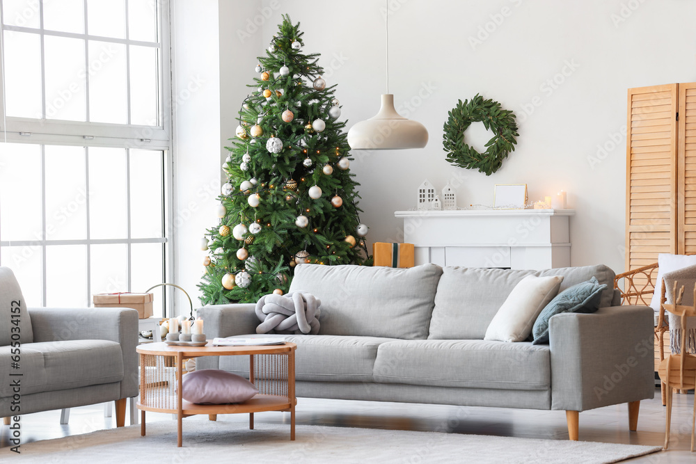 Interior of festive living room with Christmas tree and decorations