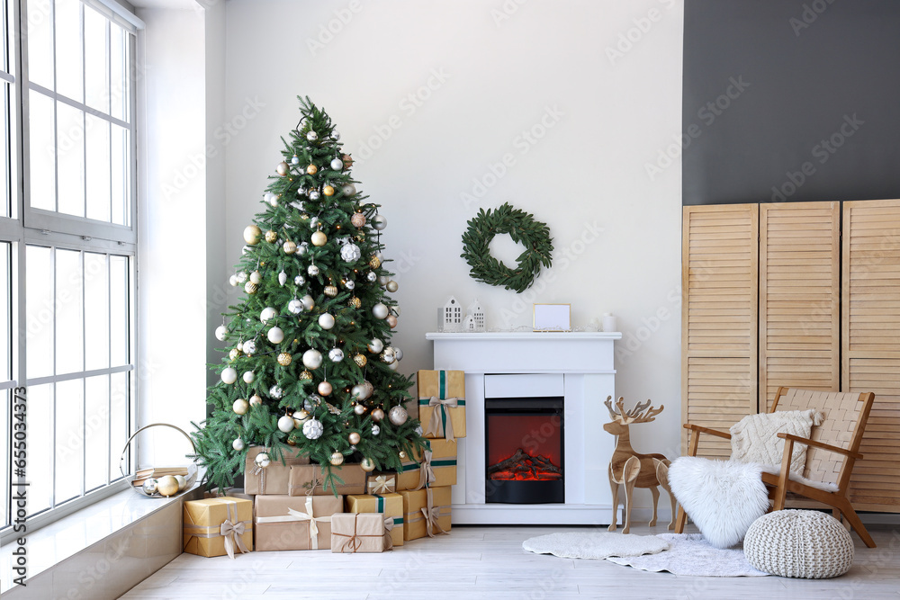 Interior of festive living room with gift boxes under Christmas tree