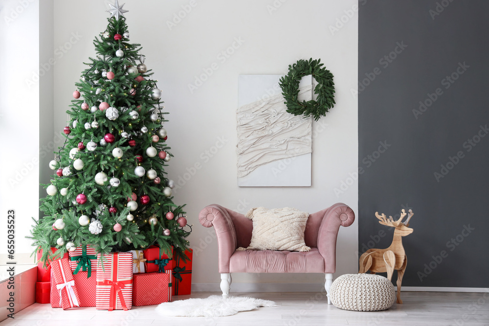 Interior of festive living room with gift boxes under Christmas tree