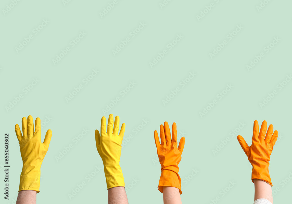 Women in rubber gloves on green background