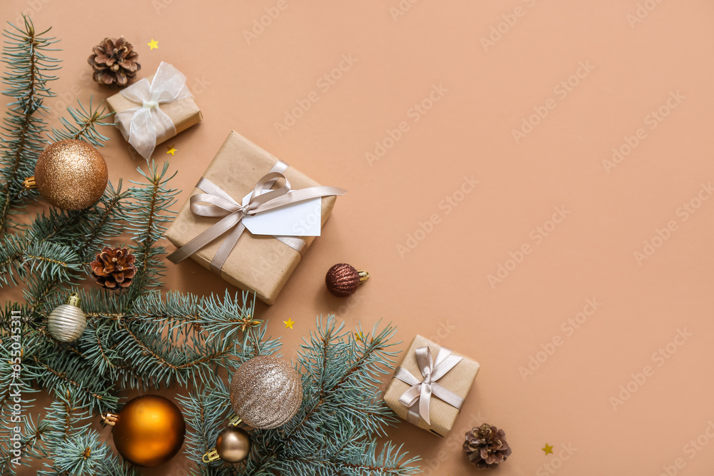 Christmas tree branches with balls and gift boxes on brown background