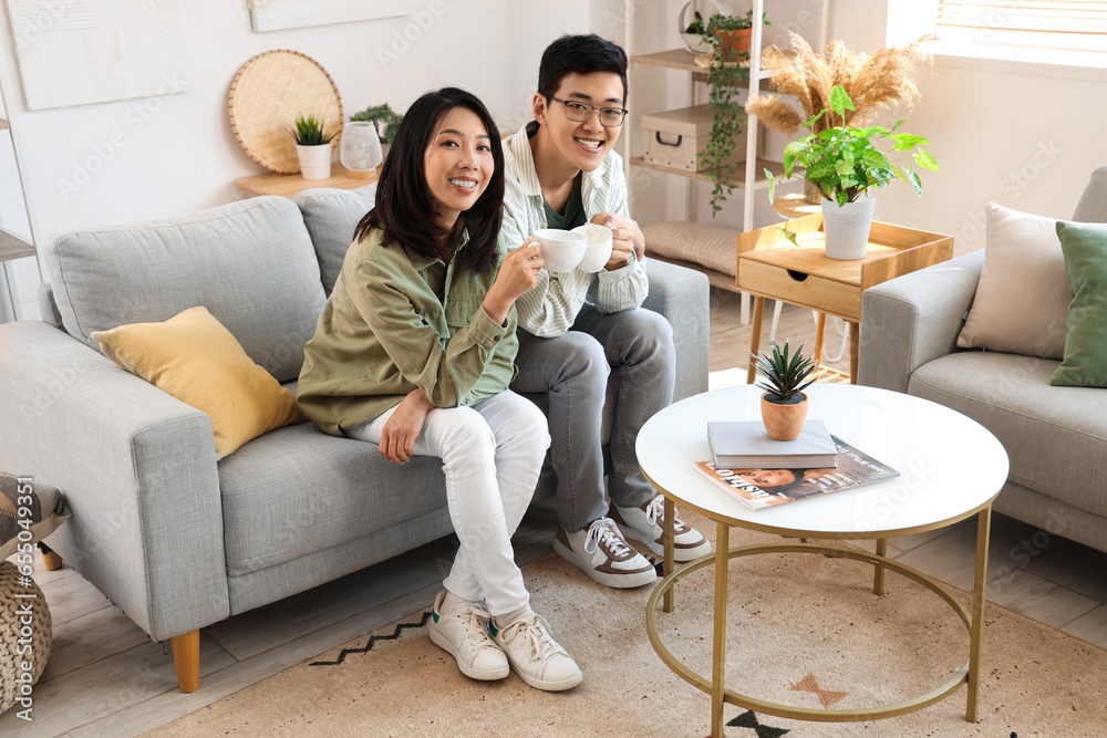 Young Asian friends drinking coffee at home