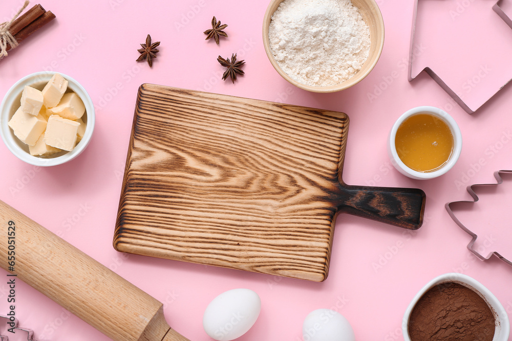 Composition with kitchen utensils and ingredients for preparing Christmas cookies on pink background