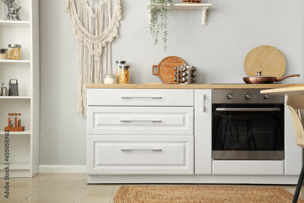 Interior of light kitchen with white counters