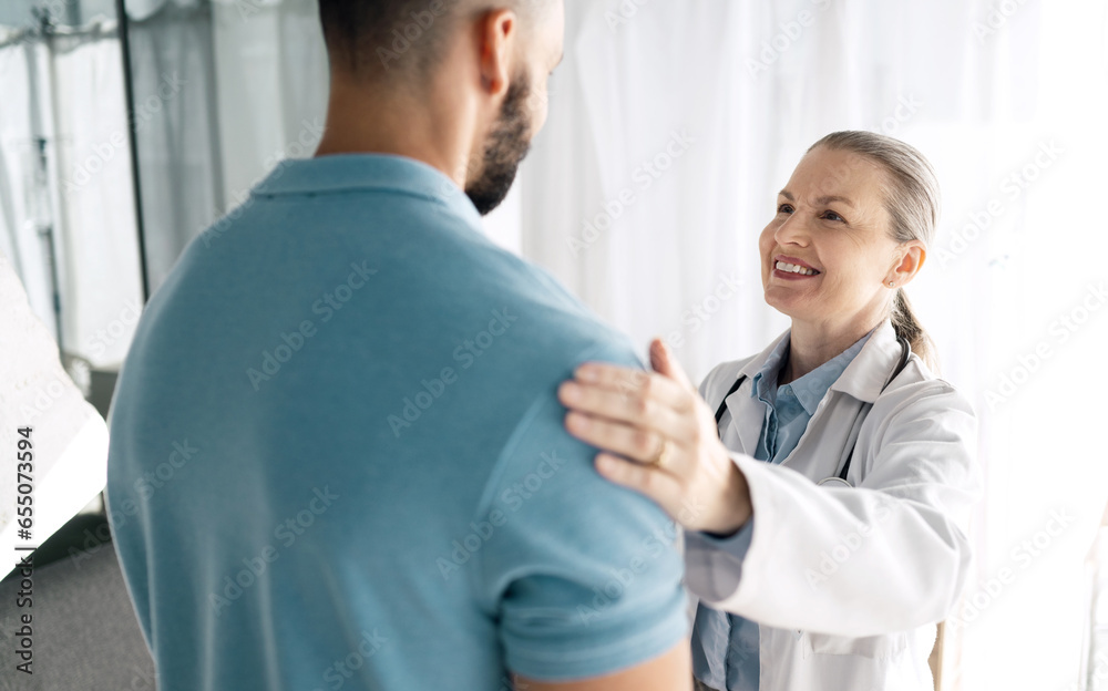 Doctor, patient and woman touch shoulder for support in consultation for healthcare, wellness or empathy. Happy medical professional comfort man for care, kindness and mature surgeon help in hospital