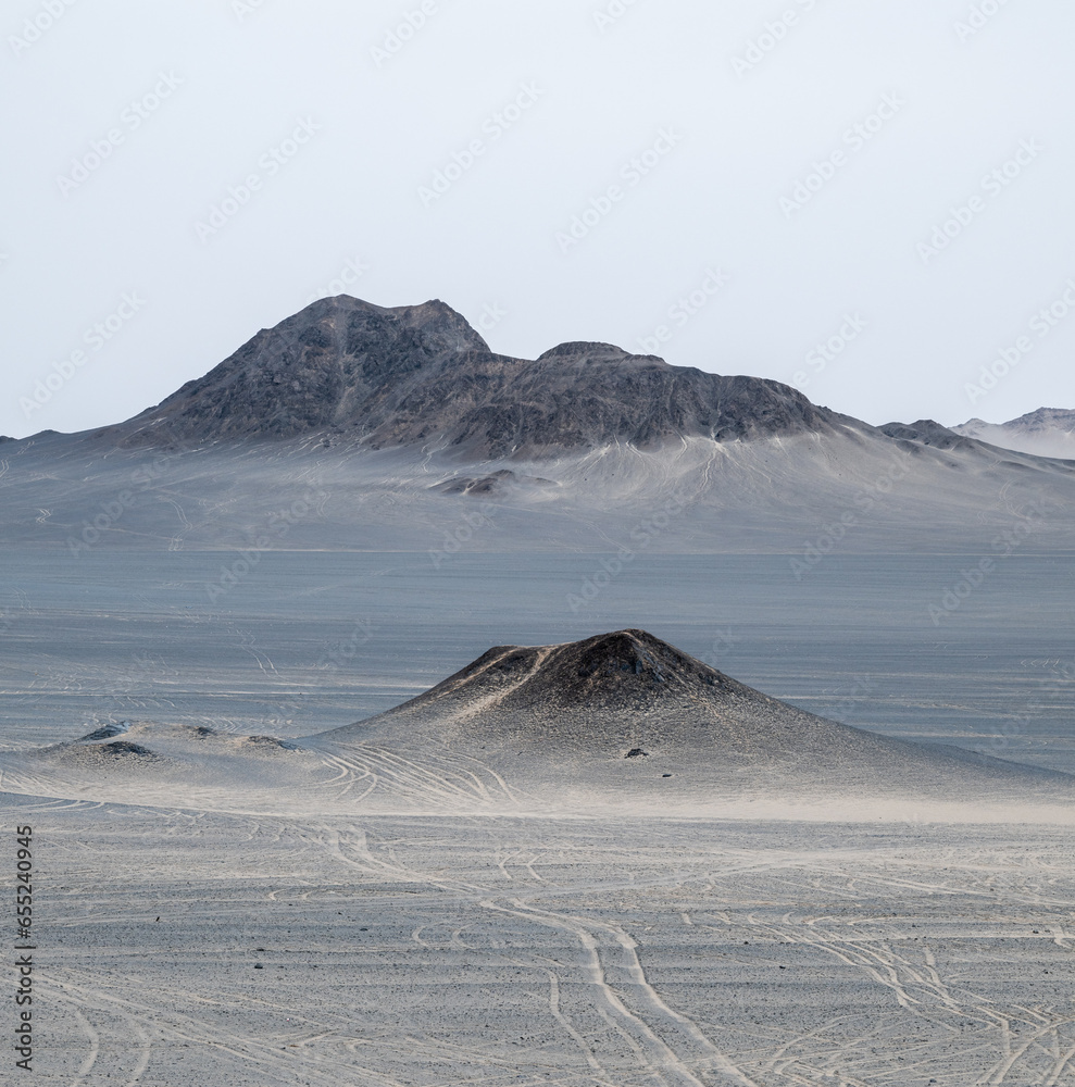 landforms of black mountain peaks which are like moon surfaces.