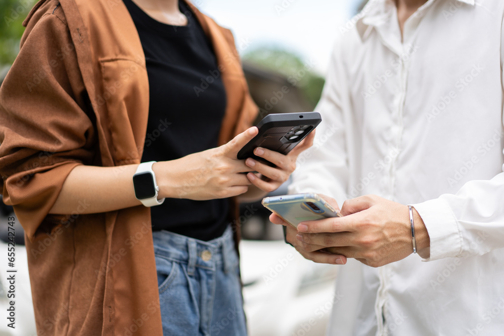 Two Drivers using a smartphone to exchange phone numbers and social media after a car accident. Concept of claim insurance for a car accident online after send photo and evidence to insurance company