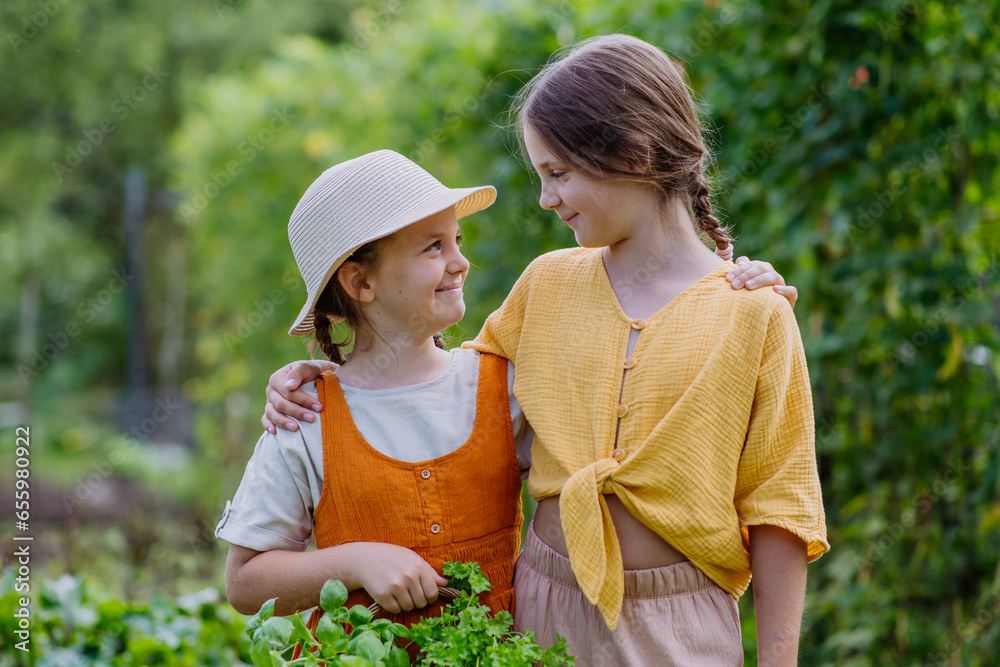 Portrait of a cute little sisters in an autumn garden.