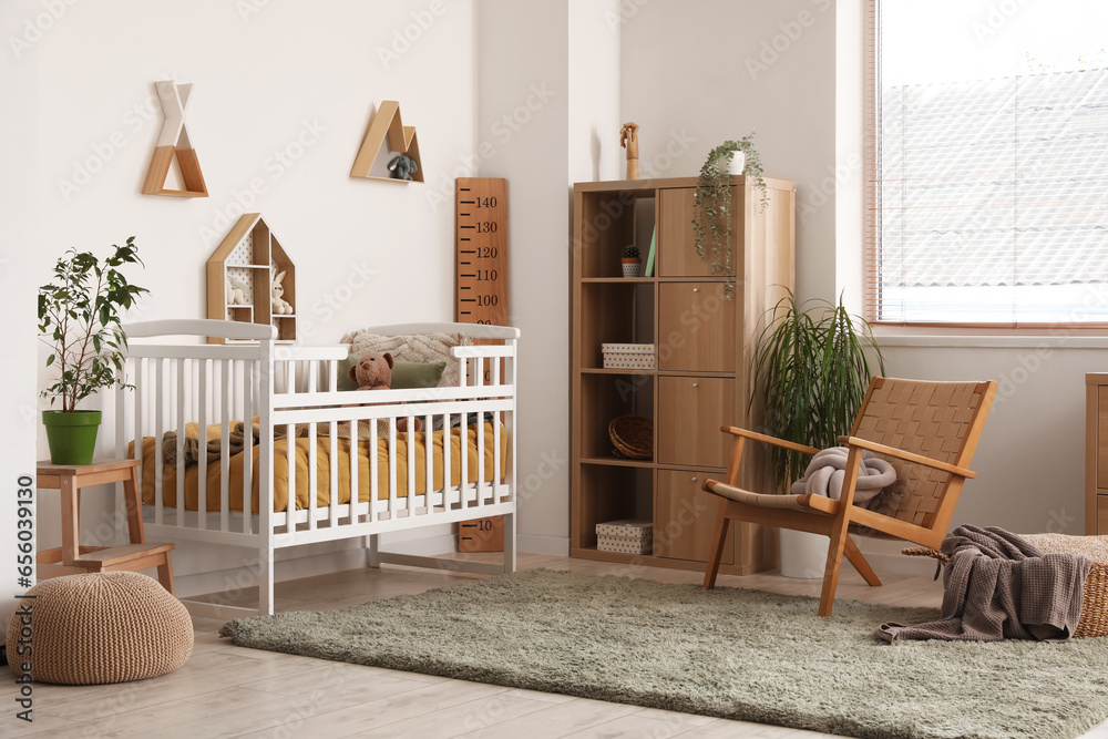 Interior of childrens bedroom with crib, shelves and toys