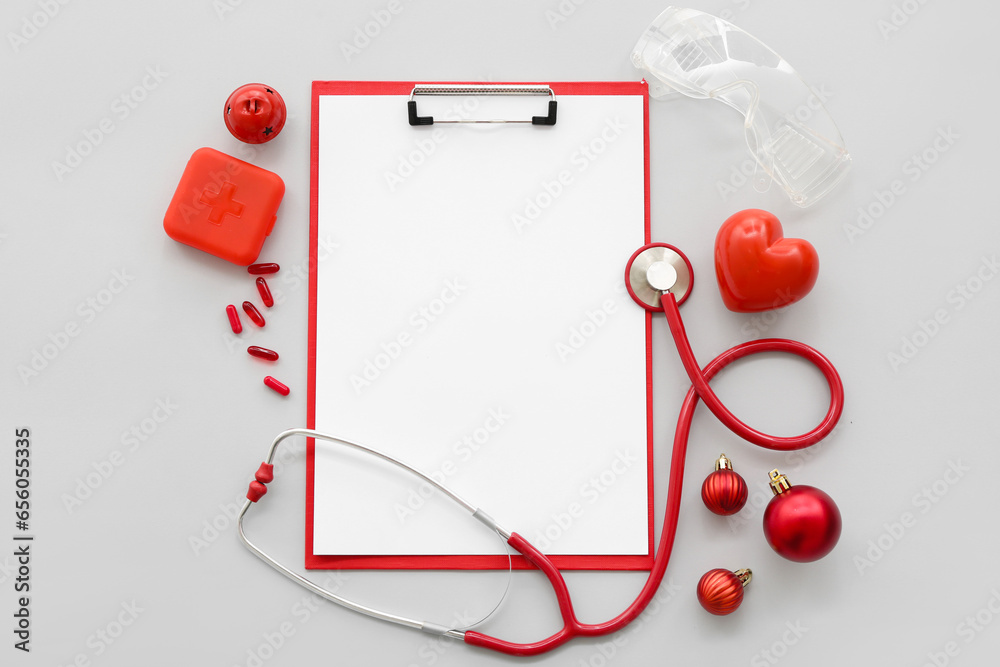 Medical supplies with Christmas decor on light background