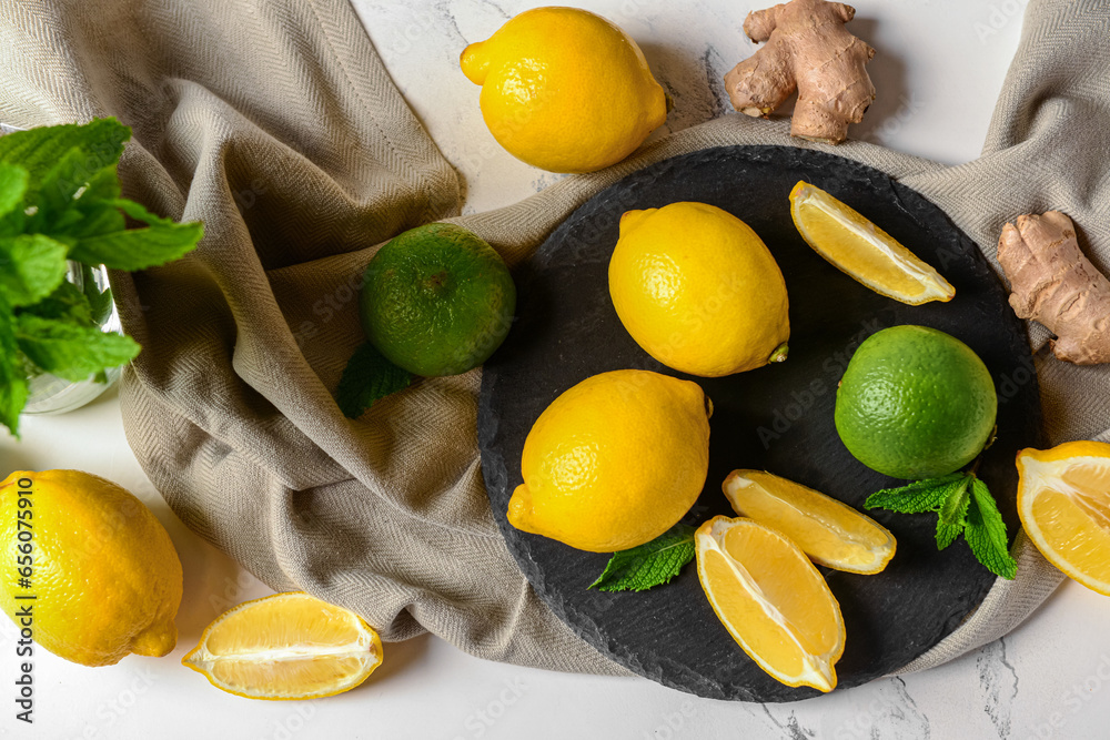 Board with different ingredients for preparing fresh lemonade on white marble background