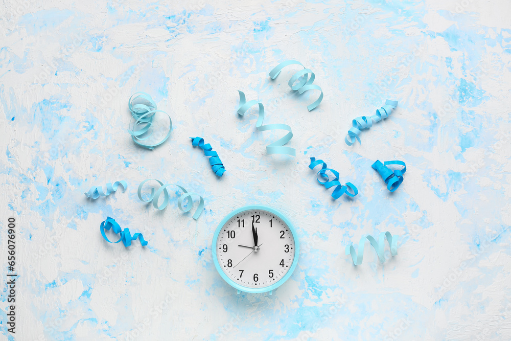 Alarm clock with confetti on light blue background