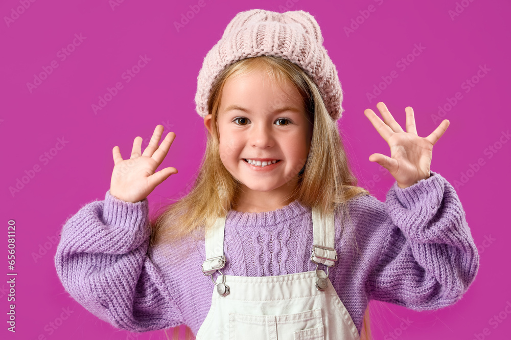 Cute little girl on purple background