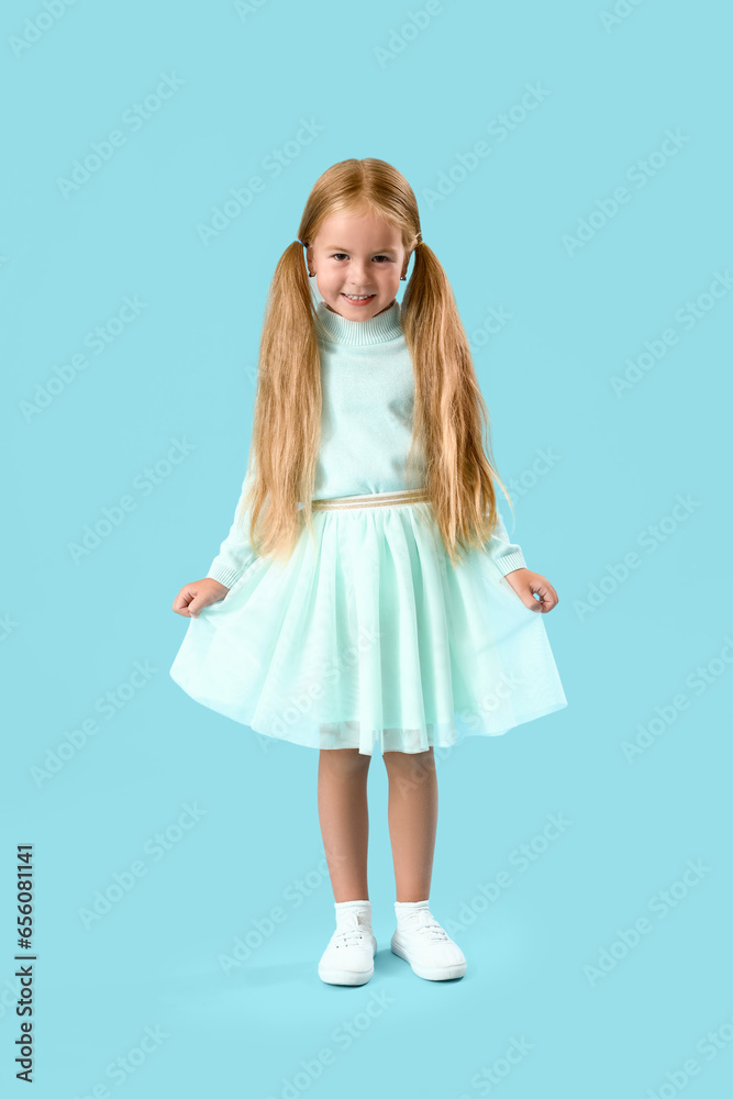 Cute little girl on blue background