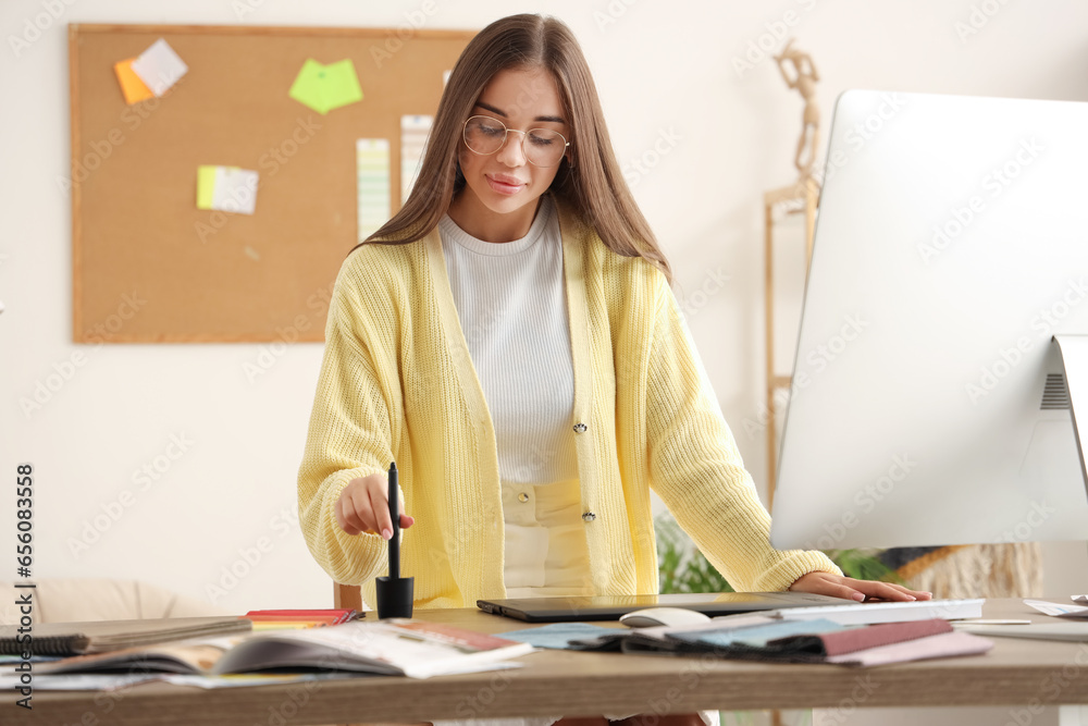 Female interior designer working at table in office