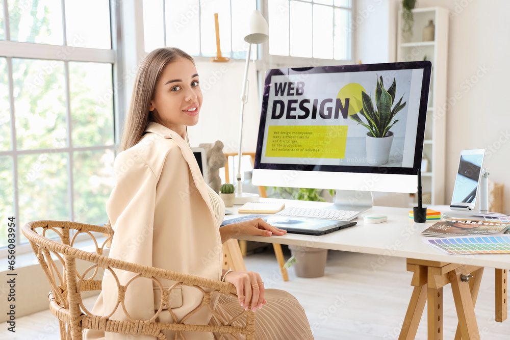 Female interior designer working at table in office