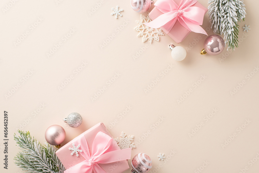 Glitzy Winter Wonderland: Top view of pink present boxes, cute tree trinkets, glistening balls, icy snowflakes, frosty evergreen twigs on subtle beige base. Space for New Years wishes or advertising