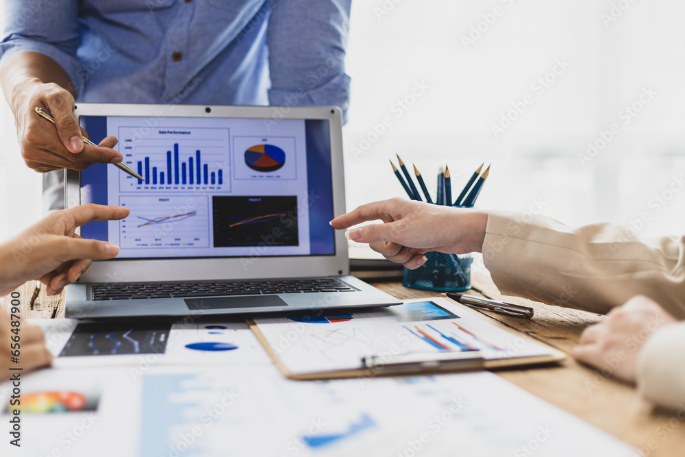 Business people discuss marketing growth chart and make business plan. Business meeting, financial consultants brainstorm analysis of statistical charts in financial reporting documents.