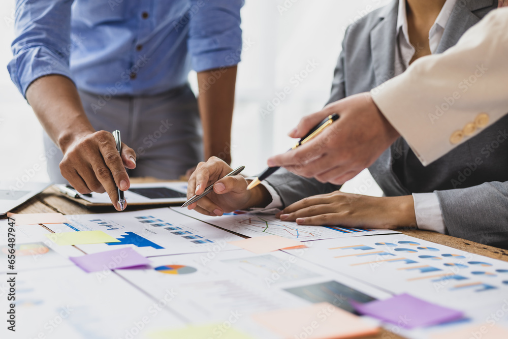 Business people discuss marketing growth chart and make business plan. Business meeting, financial consultants brainstorm analysis of statistical charts in financial reporting documents.