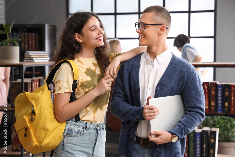 Female student with her classmate in library