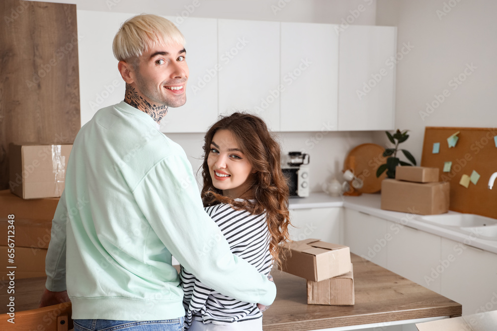 Young couple hugging in kitchen on moving day