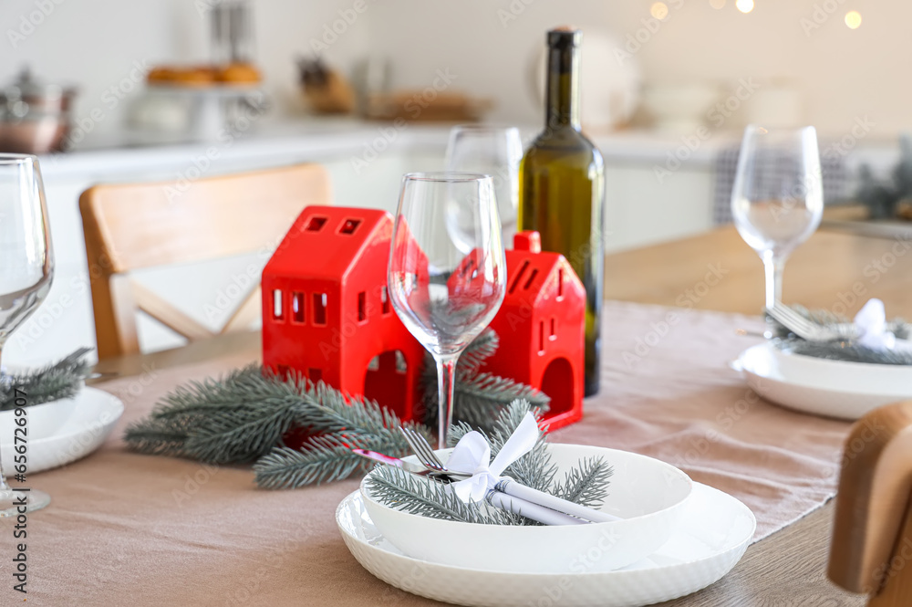 Beautiful table setting with Christmas decorations in festive kitchen, closeup