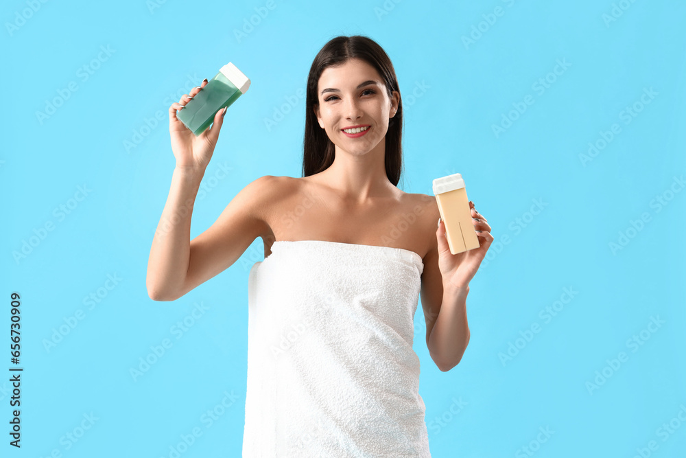 Young woman with liposoluble wax cartridges on blue background