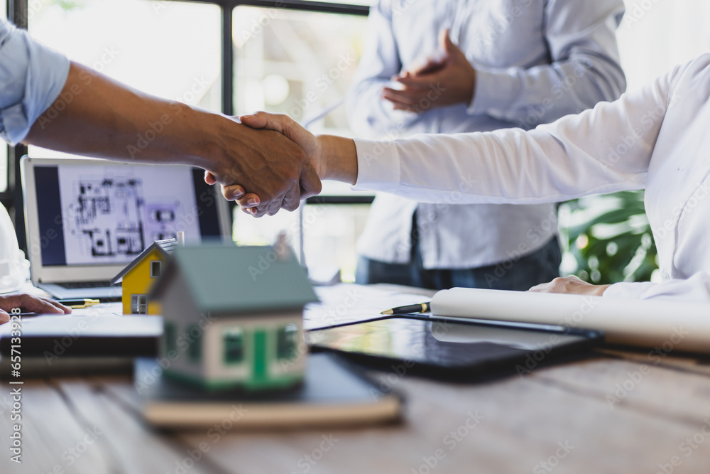 Collaboration of engineers, architects and contractors. Architects hand in hand promote teamwork cooperation of colleagues in construction projects.