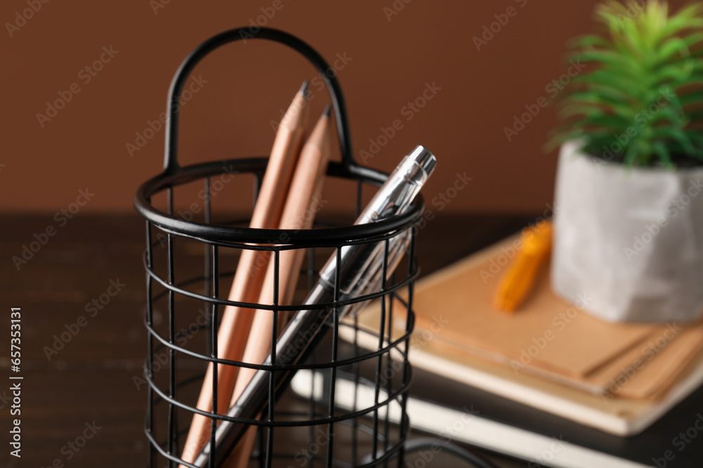 Stylish holder with ordinary pencils and pens, closeup