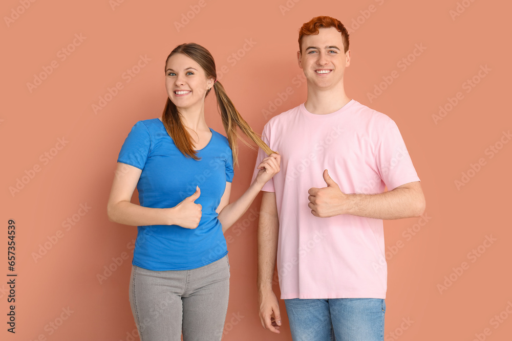 Young couple in t-shirts showing OK on beige background