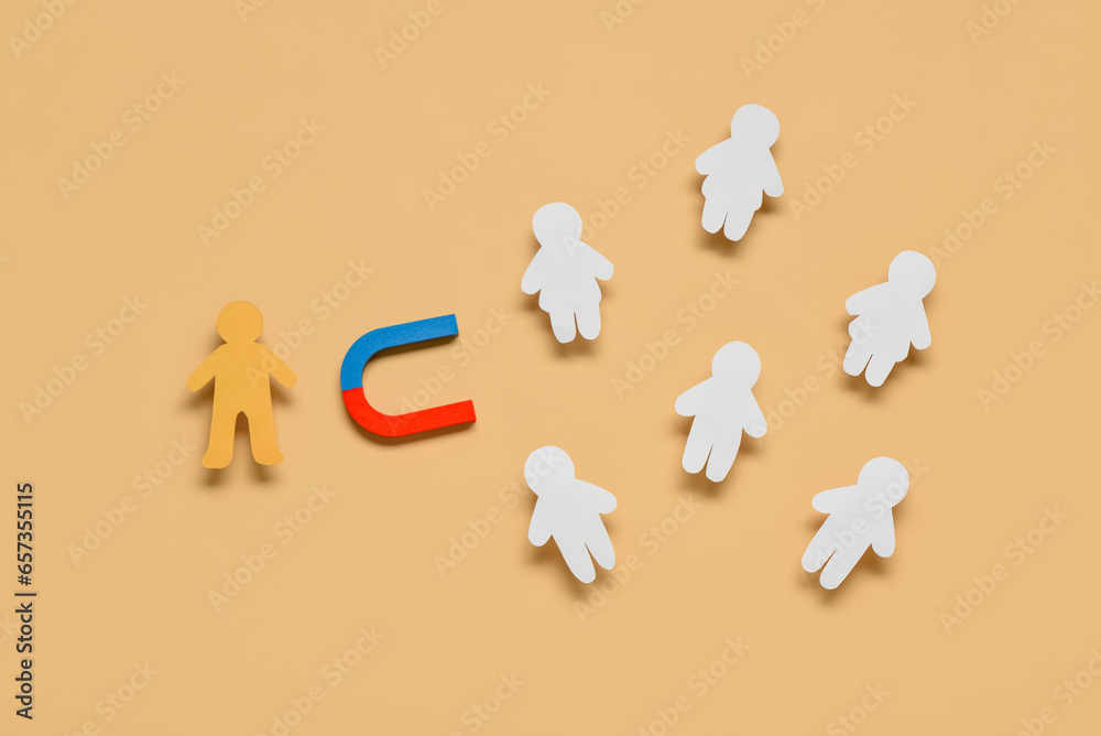 Magnet with leader and group of customers on orange background. Marketing concept