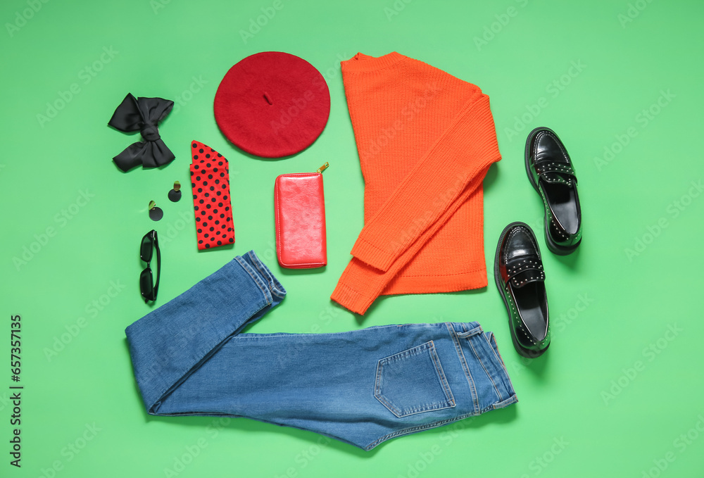 Composition with stylish female accessories, clothes and shoes on green background