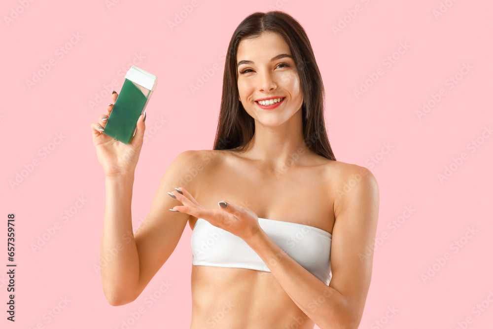 Young woman with liposoluble wax cartridge on pink background