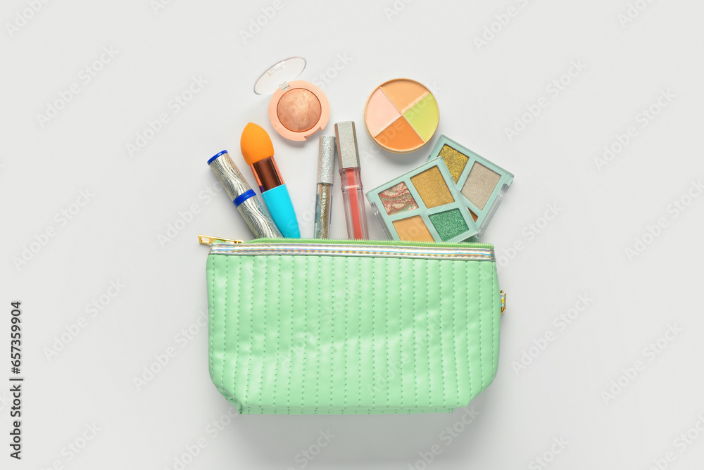 Bag with decorative cosmetic products on white background