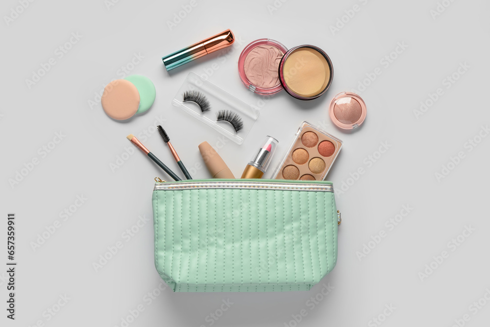 Bag with decorative cosmetic products on white background