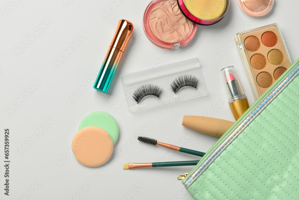 Bag with decorative cosmetic products on white background