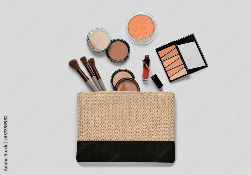 Wicker bag with decorative cosmetic products on white background