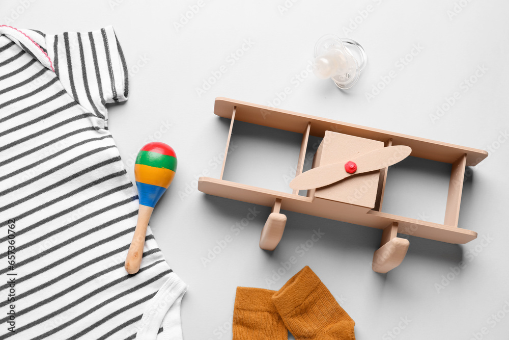 Set of baby clothes and toys on grey background, closeup