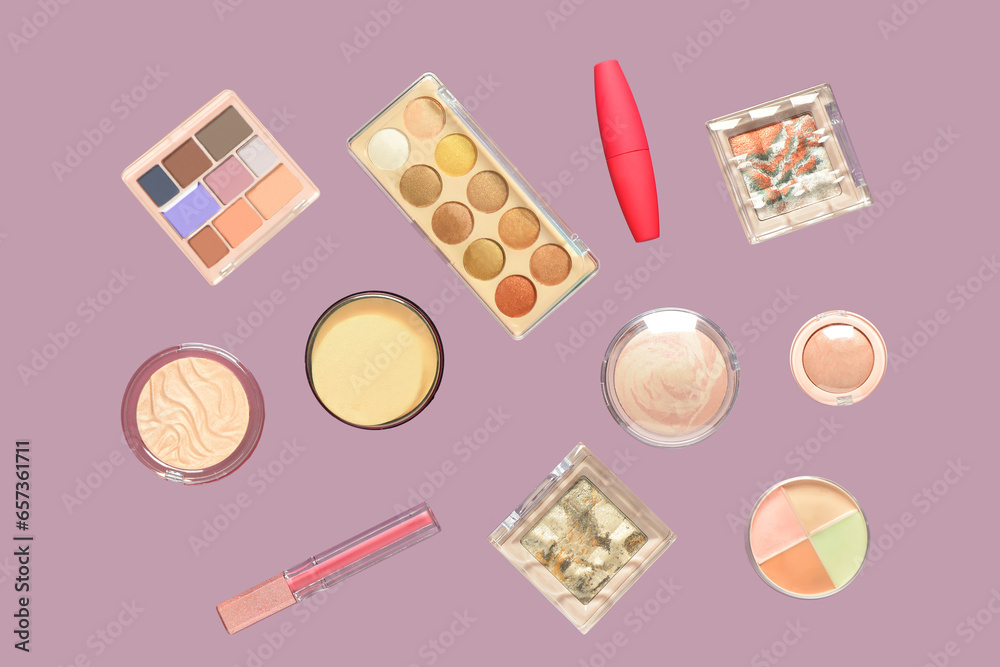 Different cosmetic products flying on lilac background