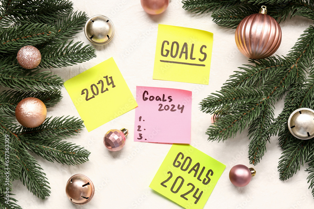 Christmas balls, fir branches and sticky notes with different goals for 2024 on white background