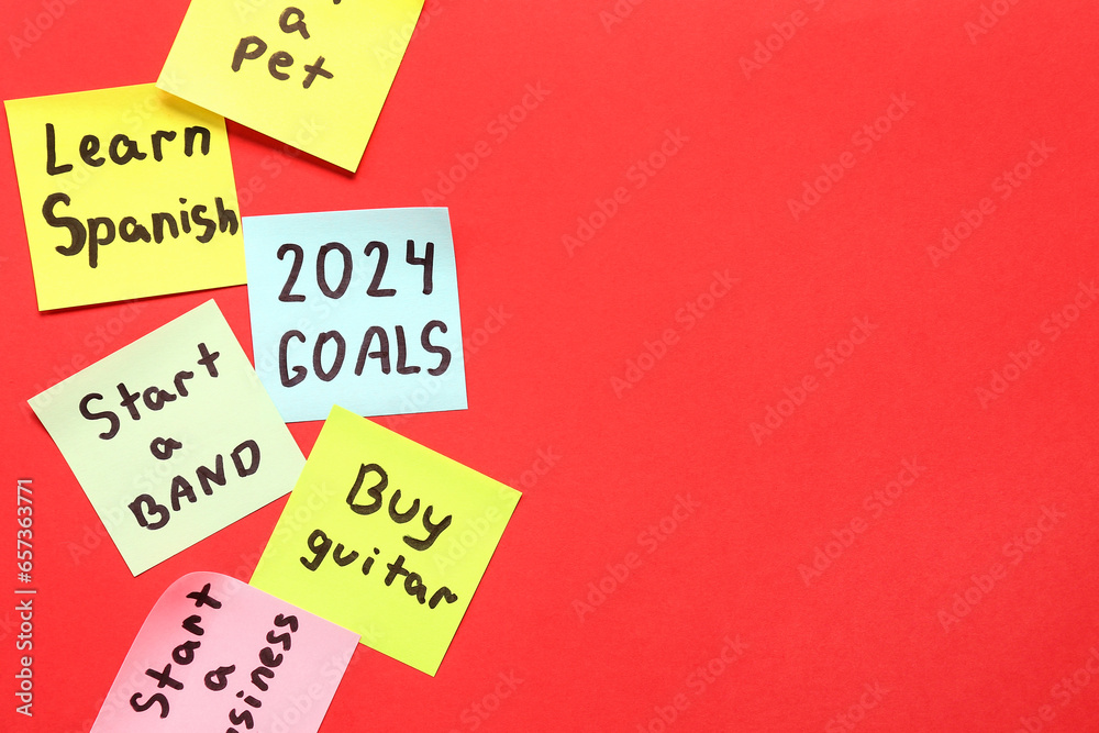 Sticky notes with different goals for 2024 on red background