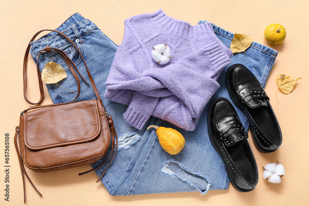 Composition with stylish female clothes, accessories and autumn decor on color background