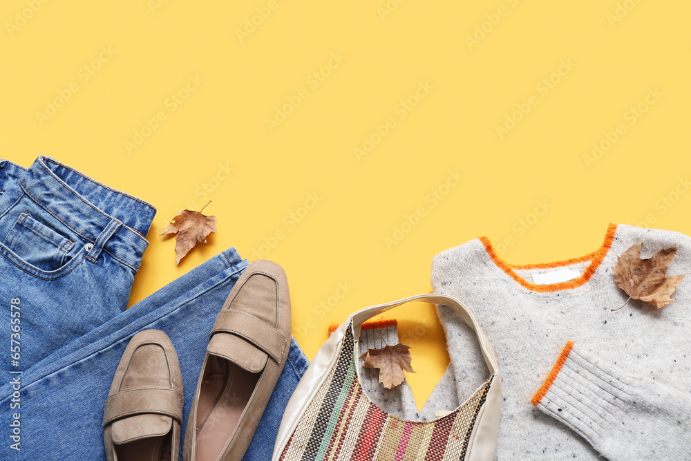 Composition with stylish female clothes, handbag and shoes on yellow background