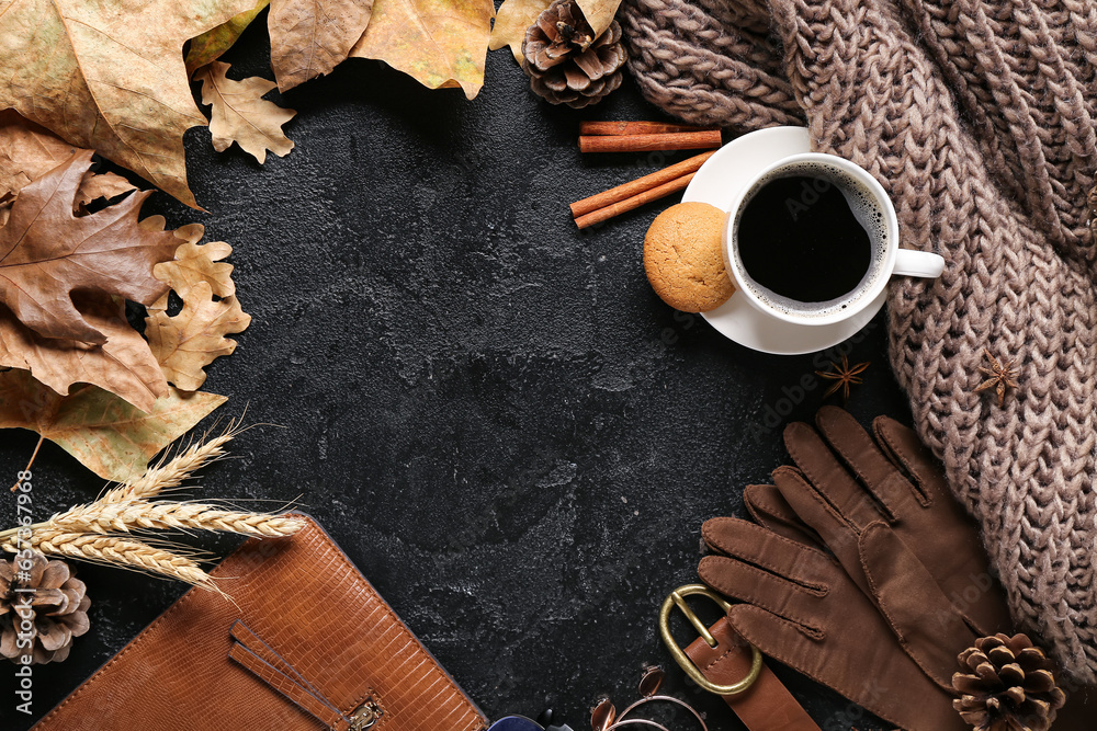 Frame made of female accessories, cup of coffee and autumn leaves on dark background, closeup