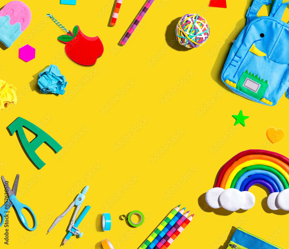 School supplies with a rainbow - overhead view - flat lay