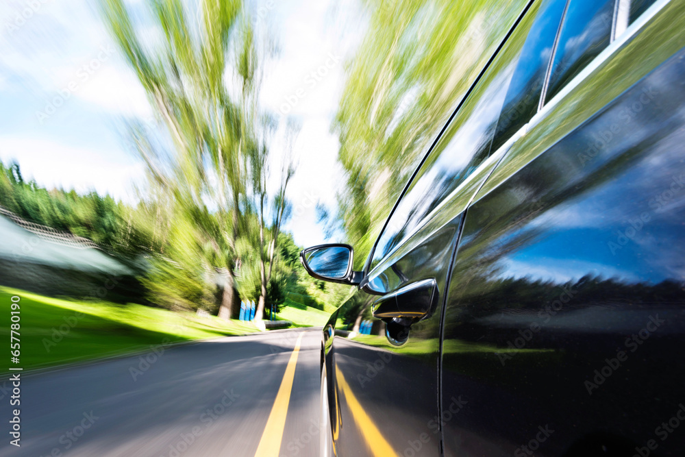 Car in motion blur driving in the forest