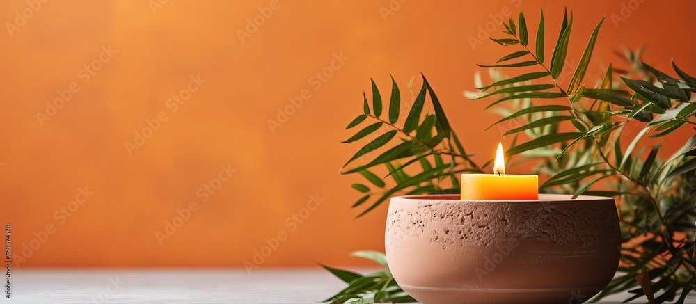 Scented coconut wax candle in orange concrete cup with lid for interior along with plaster planter lighted and natural